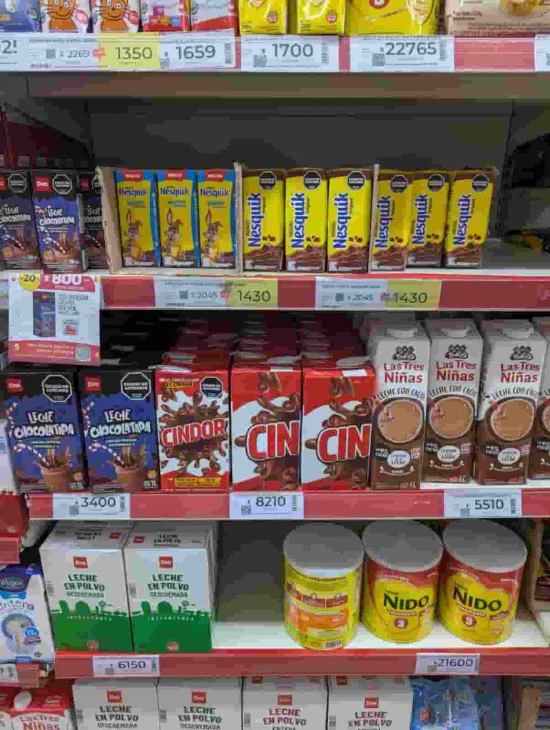 una góndola de supermercado llena de productos de leche como Cindor y Nesquik
